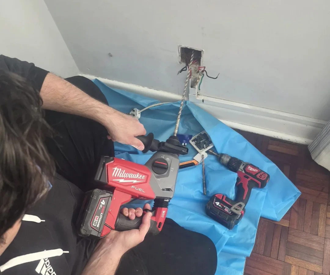 New socket outlet being wired in, existing circuit exposed and protected