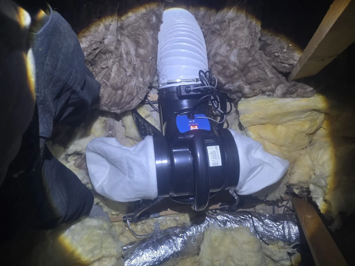Inline extract fan and ducting installed above a bathroom ceiling